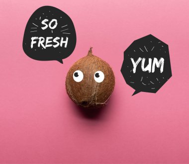 top view of whole coconut with illustrated eyes on pink background with so fresh and yum lettering in black speech bubbles clipart