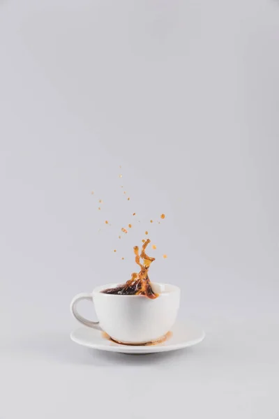 White coffee cup with splash — Stock Photo