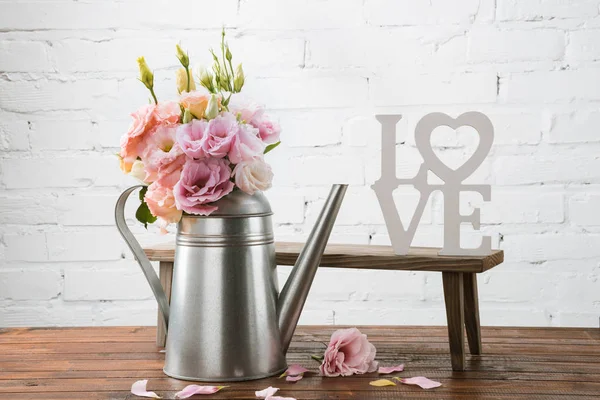 Beautiful flowers in watering can — Stock Photo