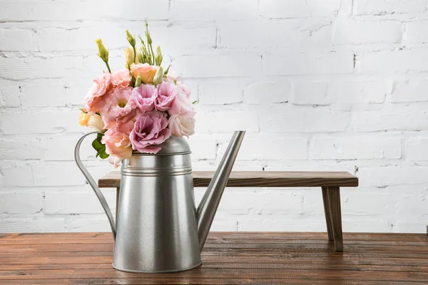 Beautiful flowers in watering can — Stock Photo