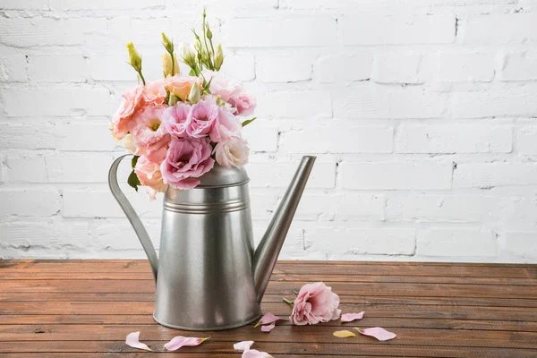 Beautiful flowers in watering can — Stock Photo