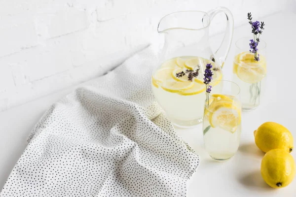 Lemonade in glasses and jar — Stock Photo