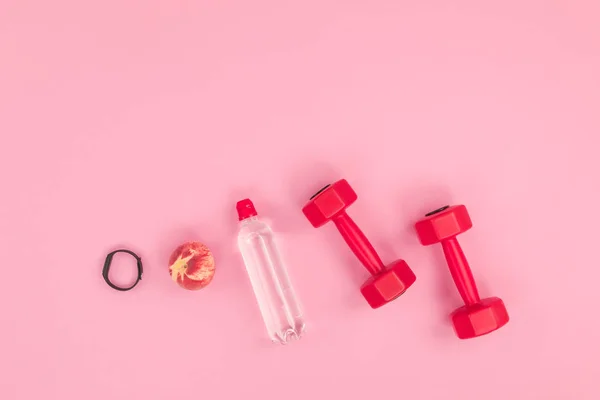 Dumbbells with water and fitness tracker — Stock Photo