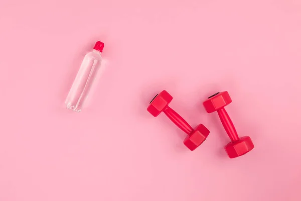 Dumbbells and bottle of water — Stock Photo