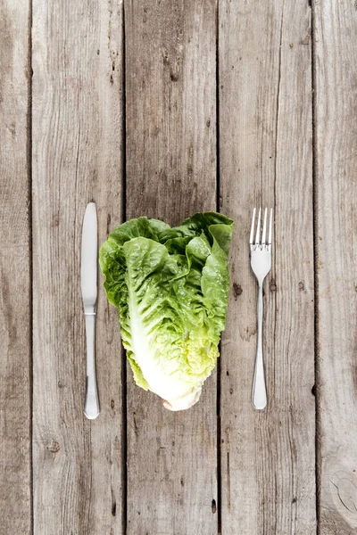 Fresh letuce salad and cutlery — Stock Photo