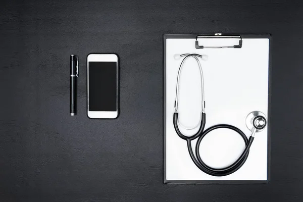 Smartphone, clipboard and stethoscope — Stock Photo