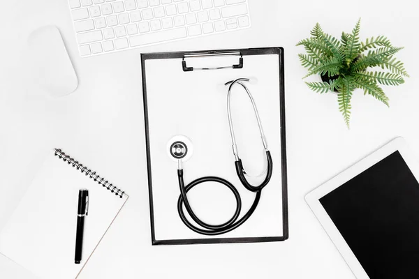 Stethoscope, clipboard and digital devices — Stock Photo