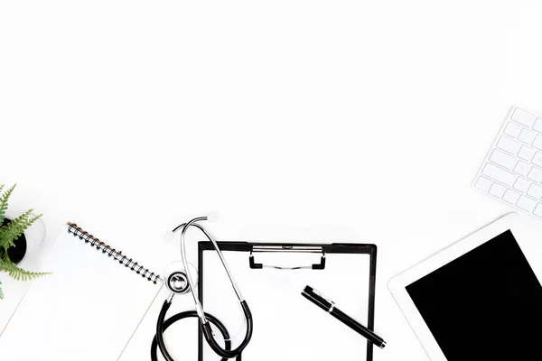 Stethoscope, clipboard and digital devices — Stock Photo