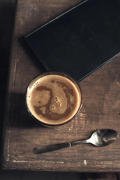 Glass of coffee and old book — Stock Photo