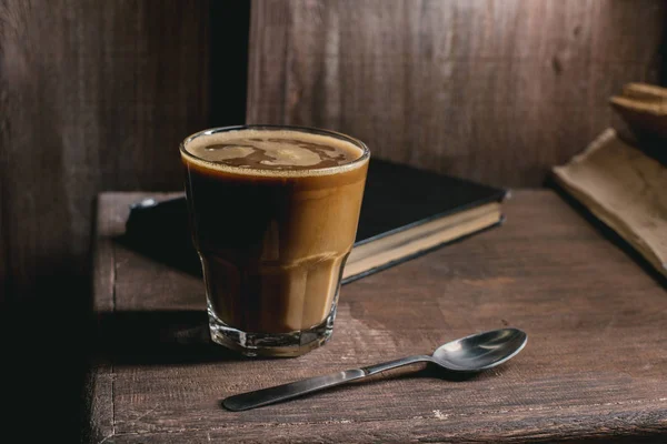 Glass of coffee and old book — Stock Photo