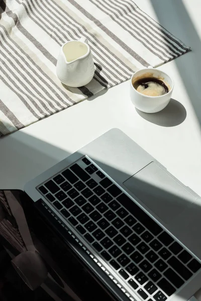 Desk with laptop cand cup of coffee — Stock Photo