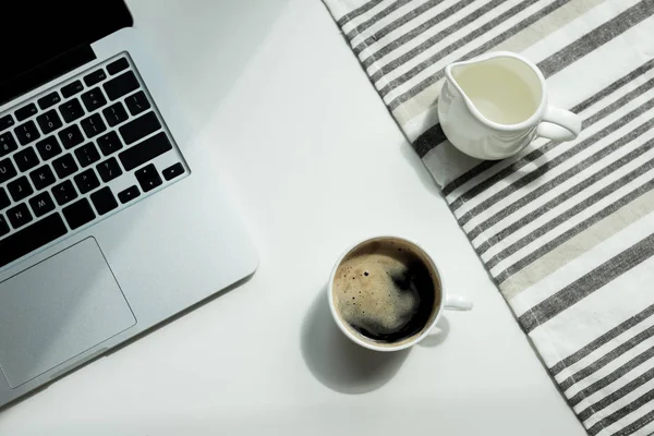 Desk with laptop cand cup of coffee — Stock Photo