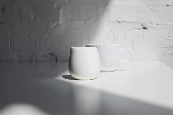 Cup of coffee and milk jar — Stock Photo