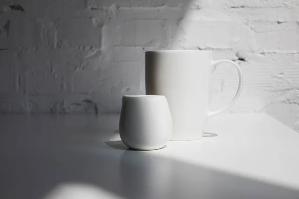 Cup of coffee and milk jar — Stock Photo