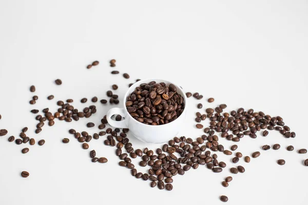 Cup with coffee beans — Stock Photo