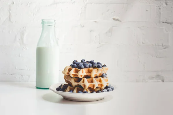 Waffles with blueberries and milk — Stock Photo