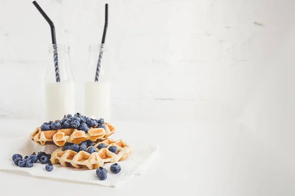 Waffles with blueberries and milk — Stock Photo