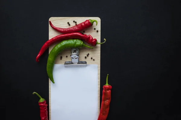 Peppers and blank paper sheet — Stock Photo