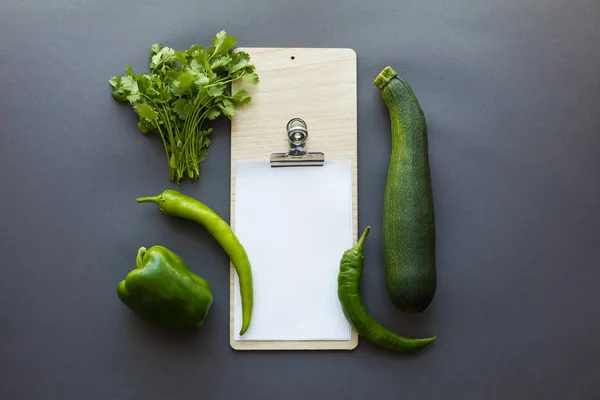 Vegetables with blank paper and cutting board — Stock Photo