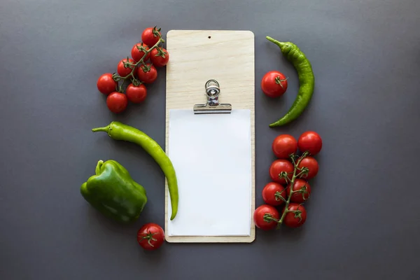 Verduras con papel en blanco y tabla de cortar - foto de stock