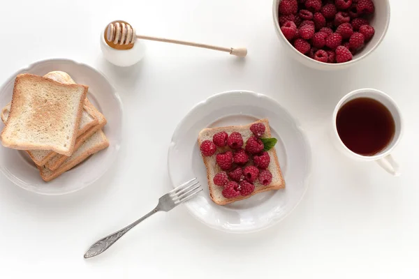 Toasts with raspberries for breakfast — Stock Photo