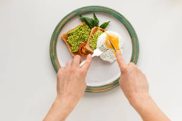 Fried egg and avocado on toasts — Stock Photo