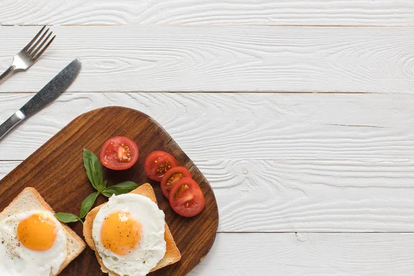 Fried eggs on toasts — Stock Photo