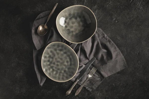 Ceramic plates and silverware — Stock Photo