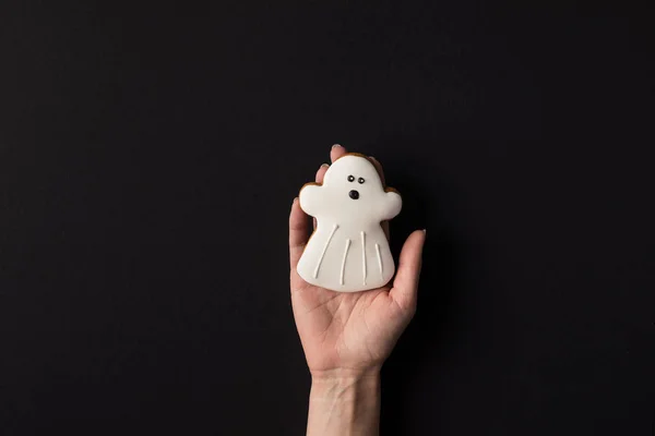 Hand with halloween cookie — Stock Photo