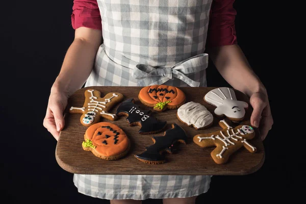 Girl holding tray with halloween cookies — Stock Photo