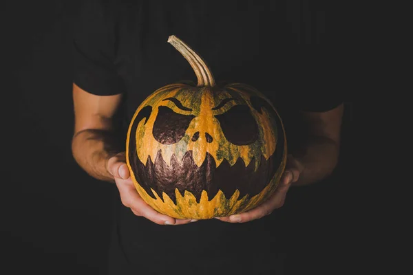 Man with pumpkin for halloween in hands — Stock Photo