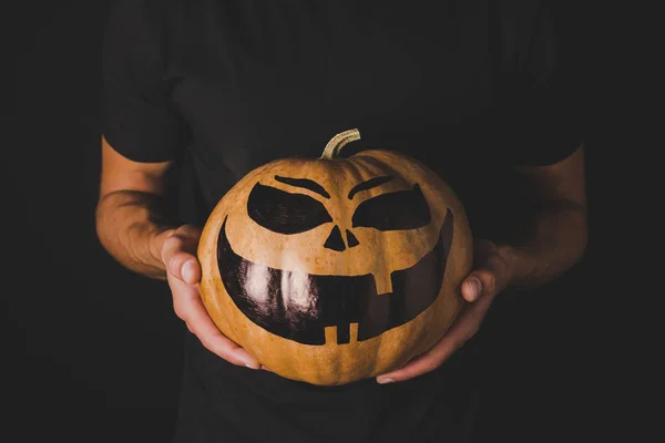 Man with pumpkin for halloween in hands — Stock Photo