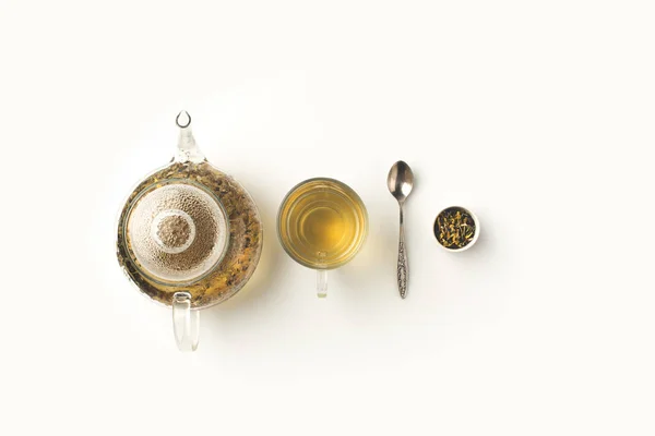 Herbal tea in cup and kettle — Stock Photo