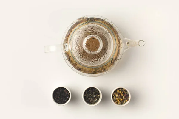 Herbal tea in glass teapot — Stock Photo