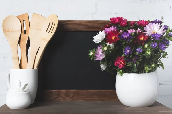 Blank board and kitchen utensils — Stock Photo