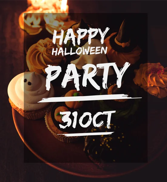 Halloween cupcakes and burning candles — Stock Photo