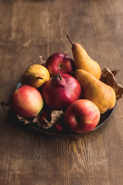 Ripe autumn fruits on table — Stock Photo