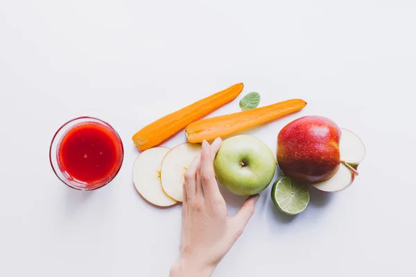 Human hand and smoothie with ingredients — Stock Photo