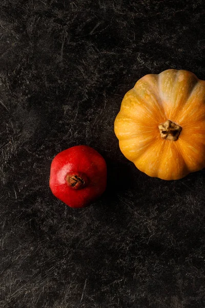 Autumnal pomegranate and pumpkin — Stock Photo