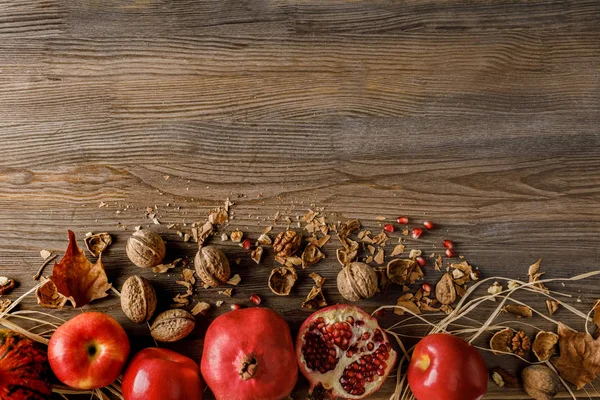 Pomegranates, apples and walnuts — Stock Photo