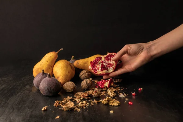 Hand with organic autumnal fruits — Stock Photo