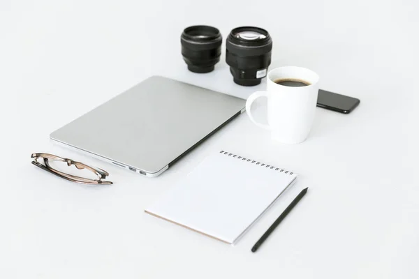 Composition with laptop and camera lenses — Stock Photo