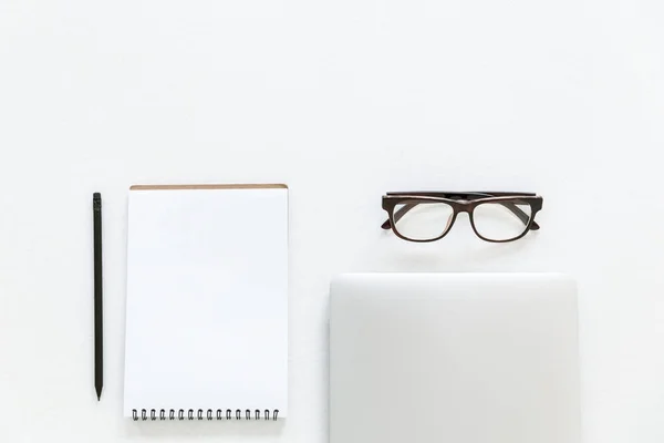 Laptop, glasses and notepad — Stock Photo