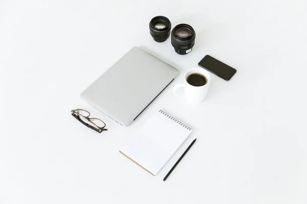 Composition with laptop and camera lenses — Stock Photo