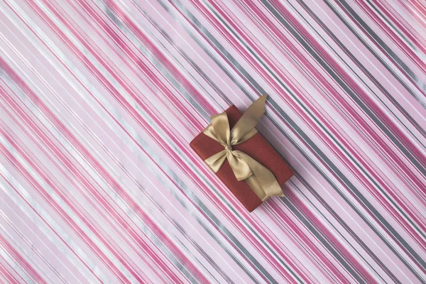 Christmas gift on wrapping paper — Stock Photo