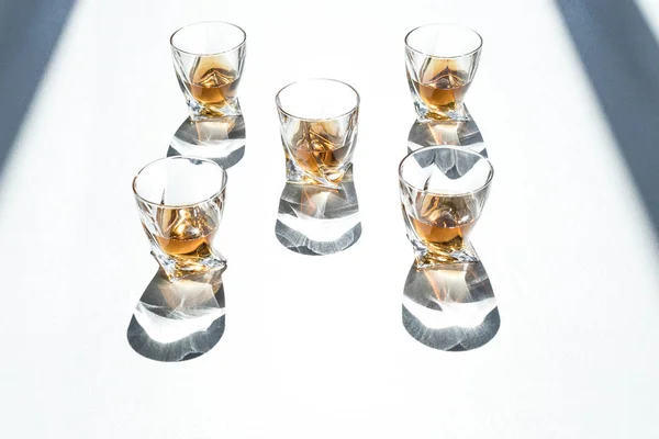 Whiskey in glasses with shadows — Stock Photo