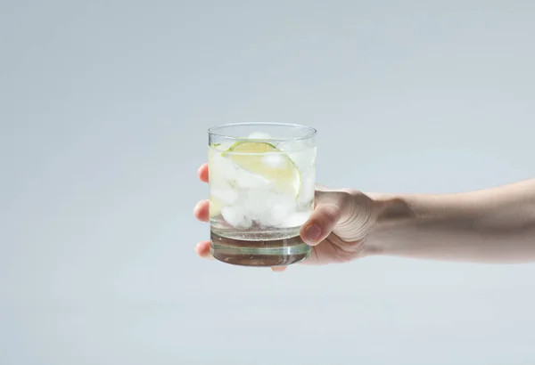 Person holding glass with cocktail — Stock Photo