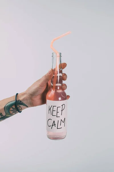 Bottle of alcohol beverage in hand — Stock Photo