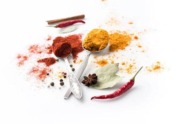 Spoons with paprika and curry — Stock Photo