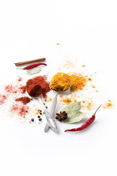Spoons with paprika and curry — Stock Photo